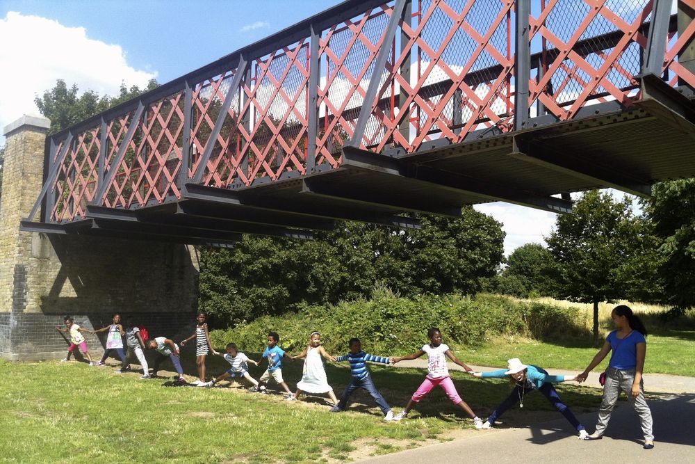 Image of the girder bridge with children linking hands beneath