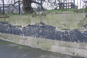 Two stone blocks just visible, embedded in concrete