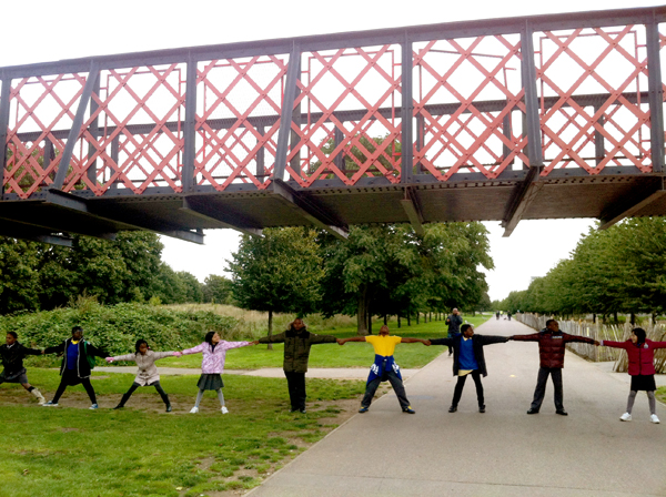 Photo of children holding hands and stretching under the bridge to nowhere to discover how wide the canal was.