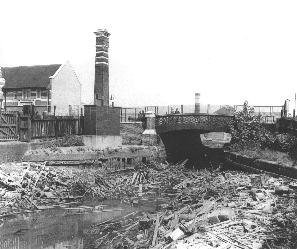 Old Library Baths and Washhouse building on the left, with Wells Way bridge over the drained canal, in about 1960